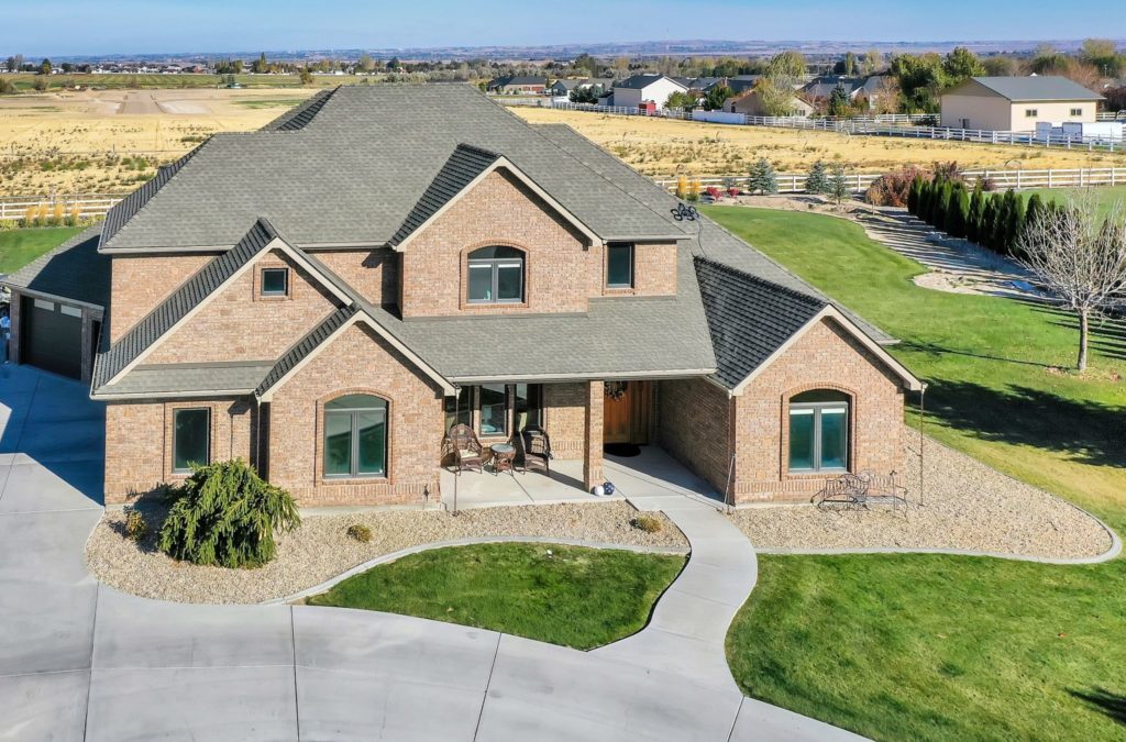 Large brick home with green grass